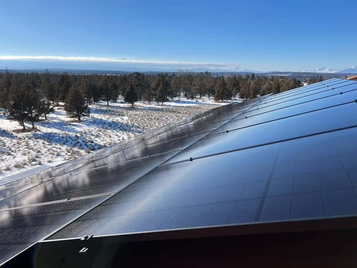 Solar panels on a roof overlooking the Central Oregon landscape.
